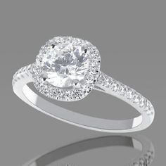 a diamond engagement ring with diamonds on the band and an oval halo setting in white gold