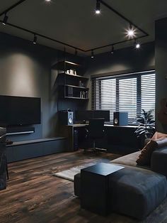 a living room filled with furniture and a flat screen tv on top of a wooden floor