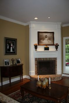 a living room filled with furniture and a fire place in front of a painting on the wall