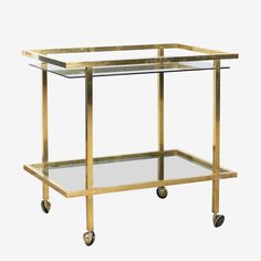 a gold metal and glass serving cart with wheels on each side, viewed from the front