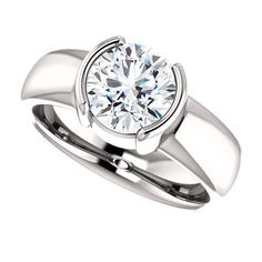 a white gold engagement ring with a round diamond