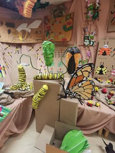 a room filled with cardboard boxes covered in paper machs and caterpillars