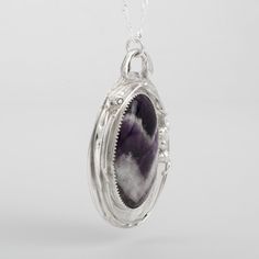 This "Murazaki" pendant necklace is handmade of 925 sterling silver. It has been hand crafted in pure 92.5% solid silver in my workshop. It features a beautiful Amethyst gemstone."Murazaki" means "purple" in japanese. Amethyst gemstone cabochon. Color: purple. Size: 35 mm Pendant overall height: approx 2 inches (5 cm); width: 1 1/2 inch (4 cm) The pendant hangs on a lovely sterling silver chain necklace. Choose your length. NOTE: This piece of jewelry has been created around this one-of-kind gem Silver Handmade Jewelry, Sterling Silver Jewelry Handmade, Sterling Silver Chain Necklace, 925 Sterling Silver Chain, Silver Chain Necklace, Amethyst Gemstone, Sterling Silver Chain, Fine Silver, Sterling Silver Chains