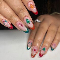 This playful nail design brings out the festive spirit with holiday symbols like gingerbread men, candy canes, and Christmas trees. The vibrant red, green, and orange almond tips framed with gold give a cheerful vibe, perfect for a winter-themed manicure. Short gel almond nails make this design wearable, while the intricate art ensures it stands out in any crowd. A true celebration of the holiday season. Vintage Christmas Nail Art, Christmas Aura Nails, Holiday French Tips, Abstract Christmas Nails, Elf Nails Designs, Holiday Nails Long, Short Almond Christmas Nails