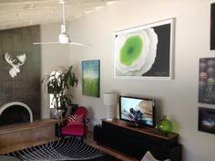 a living room filled with furniture and pictures on the wall