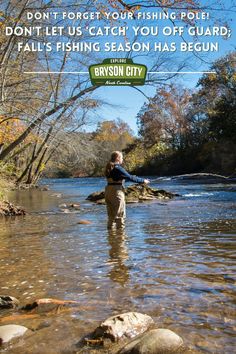 a man standing in the middle of a river with a fishing rod on his chest