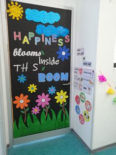 a classroom door decorated with colorful flowers and the words happiness blooms inside it's room