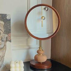 a mirror sitting on top of a wooden table