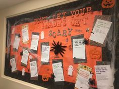 a bulletin board that has been decorated with halloween decorations and writing on the front wall