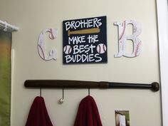 baseball themed bathroom decor with personalized signs and towel hooks for the bathtub or shower