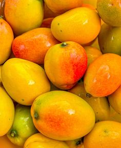 a pile of lemons and oranges sitting on top of each other in a bowl