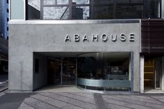 the entrance to abahouse is shown in front of a building with large windows and an awning