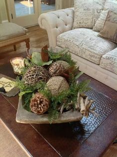 a living room filled with furniture and lots of decorations on top of a table in front of a couch