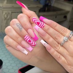 a woman's hand with pink and white nail designs