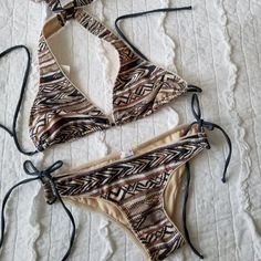 Martha Aponte Selena String Bikini. Size Small. Selena Safari Boho Print. This Designer Bikini Is Gorgeous! The Bottom Is Adjustable On The Sides. Both Top And Bottom Are Self Tie. Top And Bottom Are Included!! Fully Lined! Neutral Color Story! Brand New Tags Attached!! Sa Festival Brown Triangle Top Swimwear, Bohemian Beige Swimwear For Poolside, Fitted Beige Swimwear For Beach Party, Cream Triangle Top Swimwear For Beach Season, Beige Swimwear For Beach Festival, Fitted Beige Halter Neck Swimwear, Beige Triangle Top Swimwear For Beach, Cream Beachwear Swimwear For Vacation, Beige Tie-side Swimwear For Beachwear