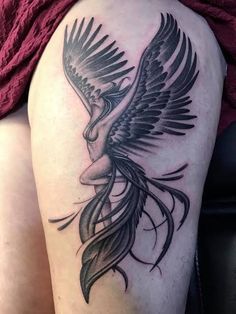 a woman's thigh with a bird tattoo on it