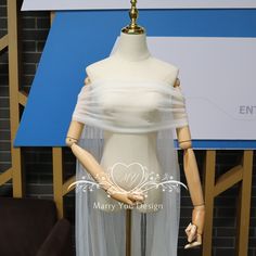 the mannequin is wearing a white dress with sheer fabric on it's sides