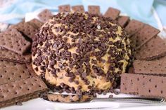 chocolate chip cookie doughnut surrounded by crackers on a white plate with a spoon