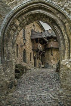 an old stone building with a large arched doorway