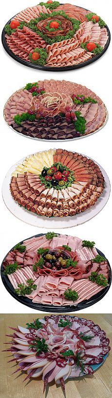 four platters with different types of meats and vegetables arranged in the shape of fish