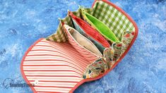 an open zippered pouch sitting on top of a blue surface