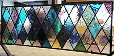 a large window with many different colored glass panels on it's sides and bottom