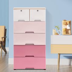 a pink and white dresser sitting in a room