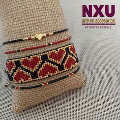 three different bracelets sitting on top of a pillow in front of a burlock