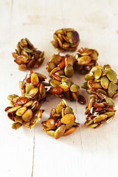 nuts are arranged on a wooden surface to be used as garnishes or desserts