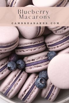 blueberry macaroons are piled on top of each other in a white bowl