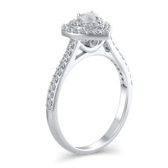 Steal her heart with the romantic details of this charming diamond engagement ring. Crafted in cool 10K white gold, this look showcases a 1/6 ct. heart-shaped diamond sparkling in a double diamond-lined frame. The shank shimmers with diamonds while hidden bezel-set diamonds adorn the gallery. Captivating with 1/2 ct. t.w. of diamonds and a bright polished shine, this engagement ring suits her sweet style. White Diamond Heart-cut Ring, White Heart Cut Diamond Ring, White Gold Diamond Ring With Heart Cut Halo Setting, White Gold Heart Cut Diamond Ring With Halo Setting, Heart Cut Diamond Halo Ring, White Diamond Heart Ring With Brilliant Cut, Elegant Heart-shaped Diamond Ring With Halo Setting, Diamond White Heart Cut Diamond Ring With Halo Setting, Heart Cut Diamond White Diamond Ring With Halo Setting