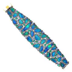 A stunning bracelet cuff is handmade in 18K gold and sterling silver. It is set in 7.97 carats emerald, 57.12 carats opal doublet, 7.42 carats tanzanite and 7.27 carats diamonds. Pair this with your favorite evening dress for a red carpet look. Clasp Closure FOLLOW MEGHNA JEWELS storefront to view the latest collection & exclusive pieces. Meghna Jewels is proudly rated as a Top Seller on 1stDibs with 5 star customer reviews. All items manufactured by us are handmade and can be customized or rede Diamond Cuff Bracelet, Gems Bracelet, Tanzanite Diamond, Sparkly Jewelry, Bracelet Cuff, Diamond Bangle, Cuff Bangles, Gemstone Bracelets, Opal Jewelry