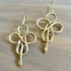 Drape yourself in serpentine elegance with our Long Snake Dangle Earrings - a stunning blend of sleek design and bold allure. Handcrafted with precision, these earrings feature a sinuous snake motif, creating an eye-catching statement piece. Material: High Quality Brass  Length of Snake itself : Approx 3 inches (7.62cm) 🐍 Key Features: - Long and graceful snake dangle design for a dramatic yet sophisticated look - High-quality brass for enduring shine and durability - Versatile style, perfect f Snake Motif, Long Snake, Snake Earrings, Snake Design, Earrings Long, Brass Jewelry, Stylish Gifts, Contemporary Fashion, Long Earrings