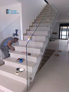 a man is painting stairs in a house