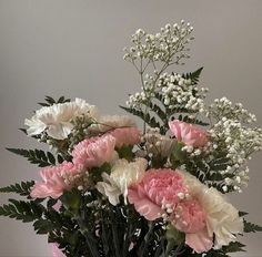 a vase filled with pink and white flowers