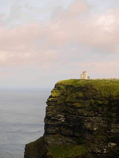 a lighthouse on top of a cliff overlooking the ocean