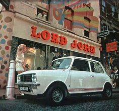 an old car parked in front of a store