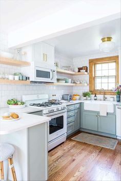 a kitchen with wooden floors and white cabinets