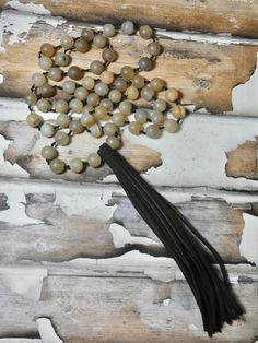 Hand knotted leather and beaded long necklace. Boho Vibe Necklace. A fun pendant and the perfect gift for that eclectic friend. I T E M ∙ S P E C I F I C A T I O N S - NECKLACE: 36" in length, Natural suede leather tassel measures 6" long, beads are about 3/8" round - RHINESTONE: Aprox. 62 beads C A R E ∙ T I P S We don’t want your special moment to fade. To maintain the quality of your jewelry, please: - Do not wear it to the pool, spa, or the beach - Remove when sleeping, exercising, or doing Adjustable Brown Hand Knotted Necklaces, Brown Adjustable Hand Knotted Necklace, Handmade Adjustable Brown Tassel Necklace, Brown Tassel Necklaces As Gifts, Adjustable Brown Hand Knotted Beaded Necklace, Adjustable Brown Hand-knotted Beaded Necklace, Adjustable Hand Knotted Brown Beaded Necklace, Adjustable Long Spiritual Tassel Necklace, Beaded Leather Necklace