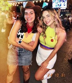 two women in costumes posing for a photo