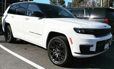 a white jeep parked in a parking lot