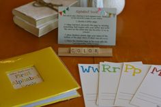 the table is set up with books and cards for children to write their name on