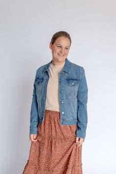 Beat that autumn chill in style with the 'Cheyenne' Jacket! This feminine denim jacket is the perfect piece for layering over your favorite dresses and pairing with fall skirts. With no weird fading or distressing, this jacket has a flattering fit and nice stretch. Style this over a t-shirt dress for a shopping day with friends or over a floral skirt and top for a night out. This is piece you can love for years to come! Fit: true to size; this jacket is less "boxy" than most jean jackets. It has Floral Skirt And Top, Day With Friends, Be Intentional, Skirt And Top, Modest Clothing, Garment Labels, Fall Skirts, Shopping Day, Curated Gifts