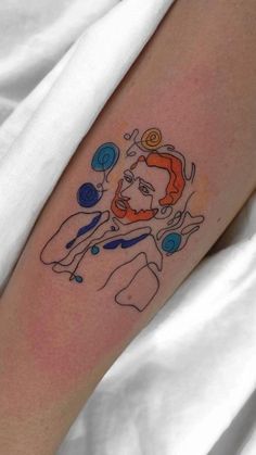 a man with a clown face tattoo on his arm