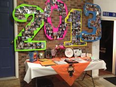 a table with pictures and photos on it in front of a brick wall that says 2012