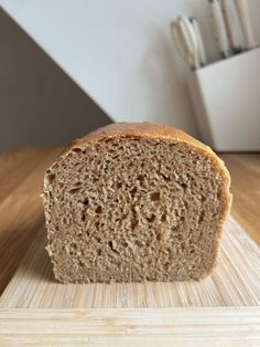 a loaf of bread sitting on top of a wooden cutting board