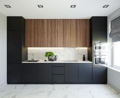 a kitchen with marble counter tops and wooden cabinets