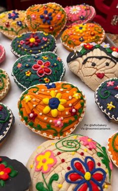 many decorated cookies are on a table