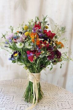 a bouquet of wildflowers tied up on a table