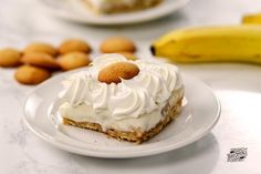 a piece of cake sitting on top of a white plate next to some banana's